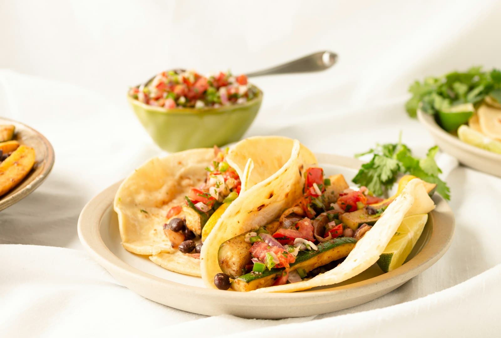 Soft tacos filled with black beans, vegetables and fresh pico de gallo