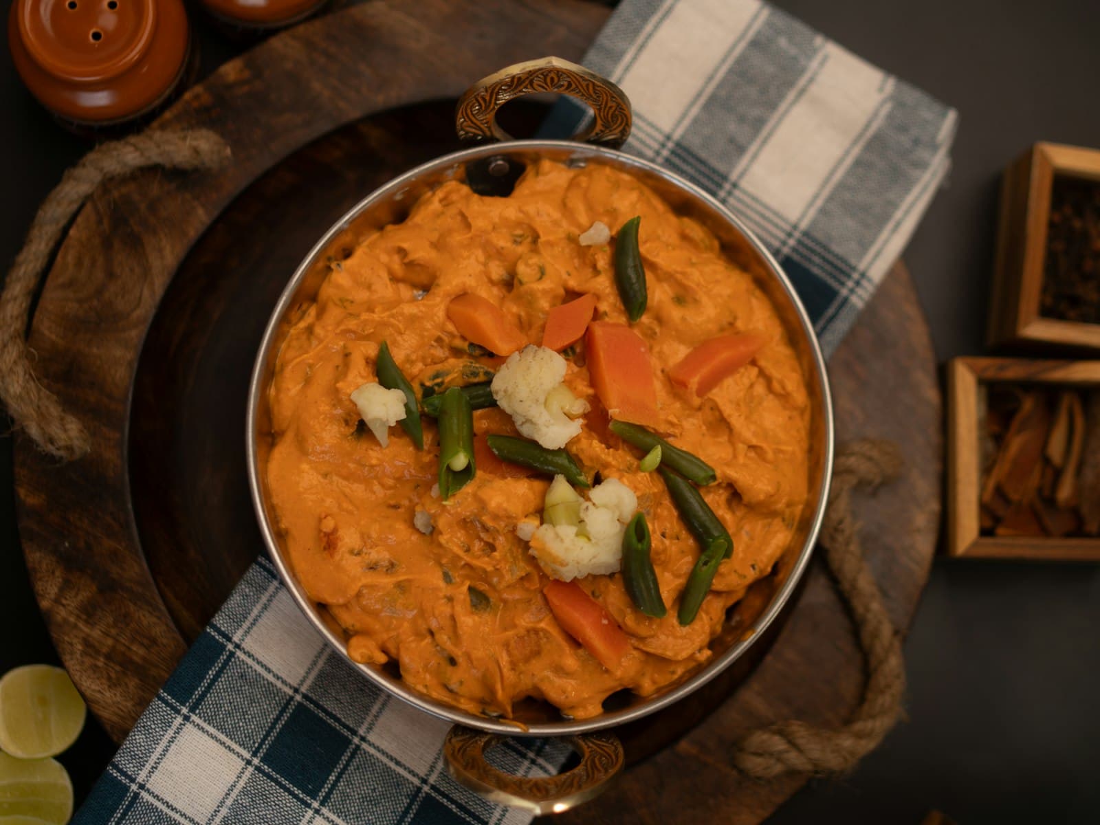 A creamy vegetable curry with cauliflower and green beans in a serving dish