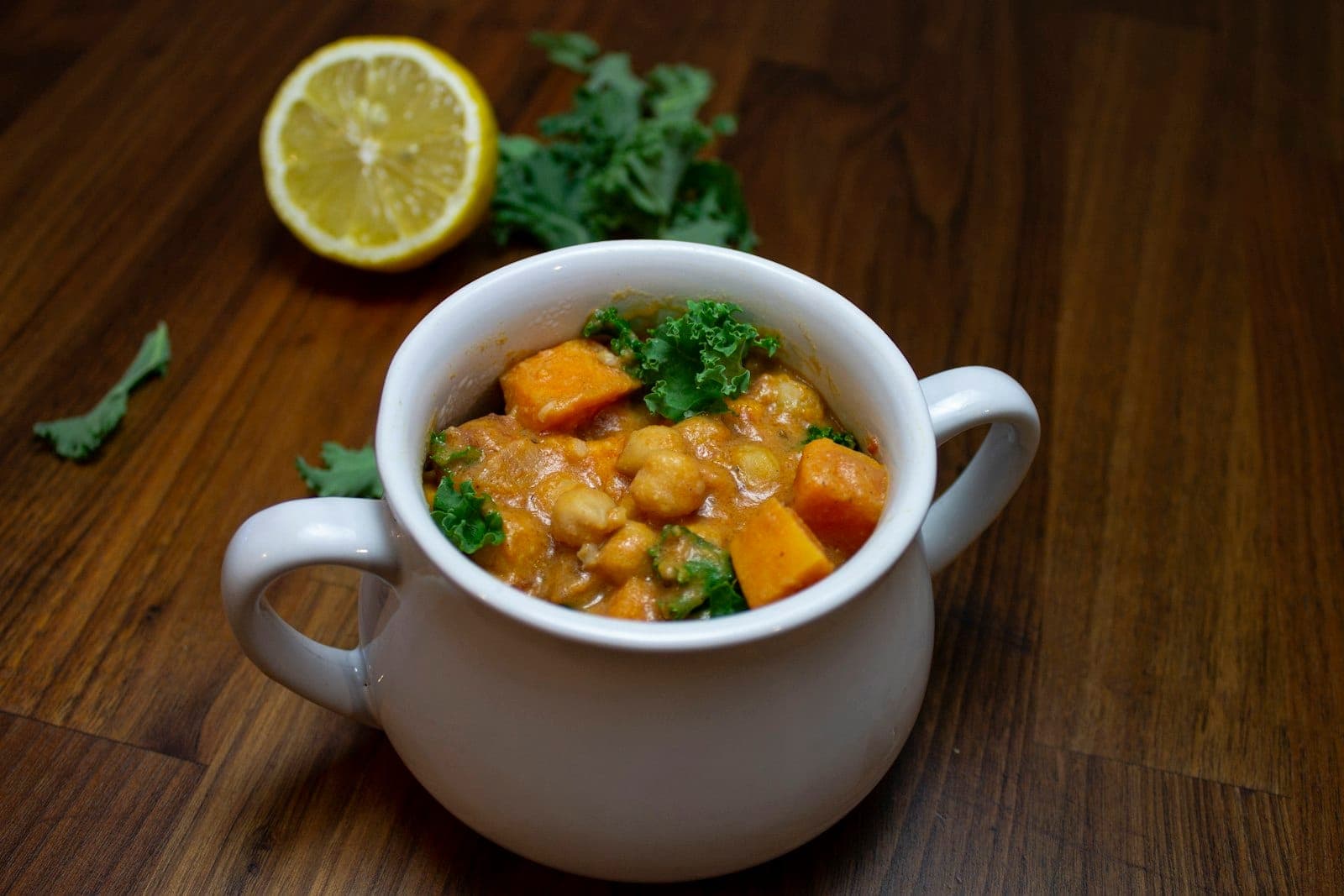 A bowl of sweet potato and chickpea stew with kale