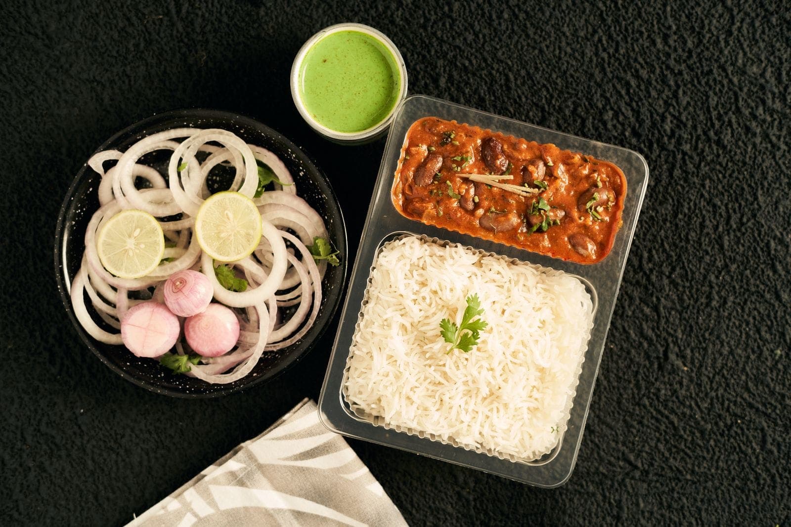Kidney bean curry with basmati rice, sliced onions and green chutney