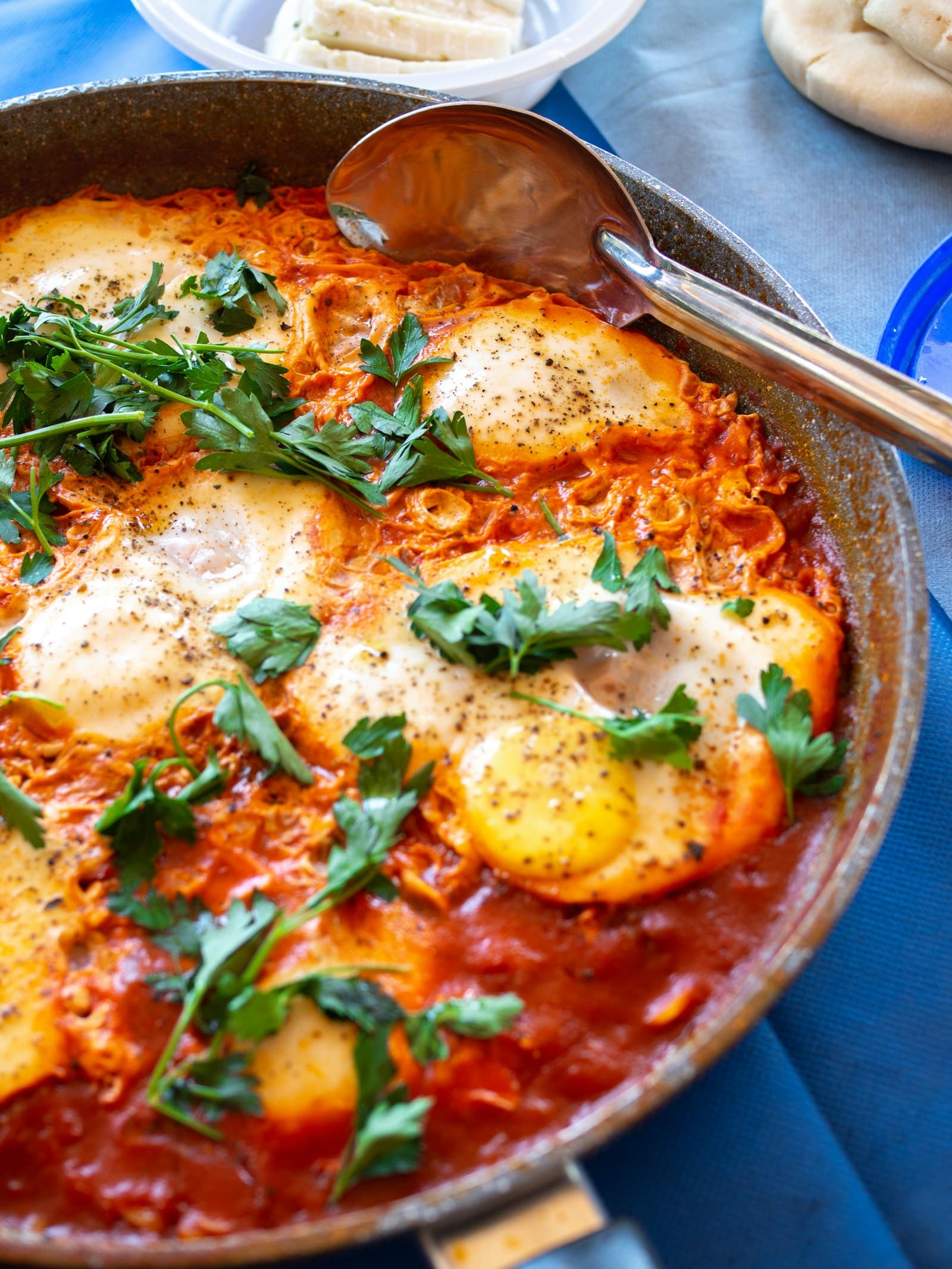 Eggs poached in a spiced tomato sauce, topped with fresh herbs