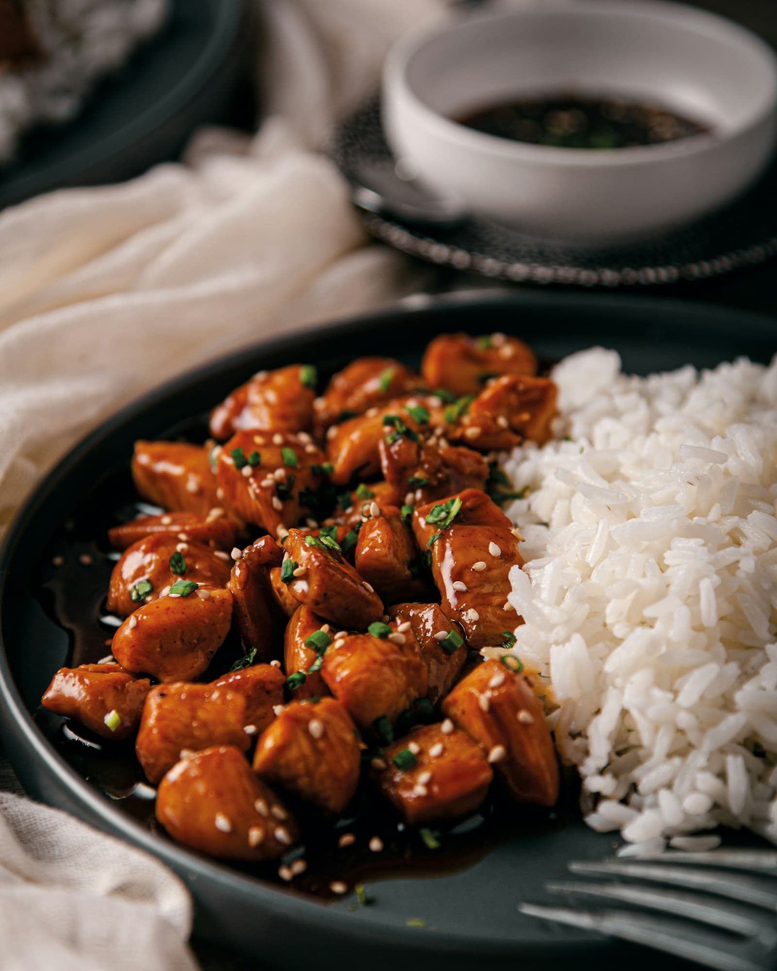 Glazed teriyaki-style chicken pieces with a side of white rice